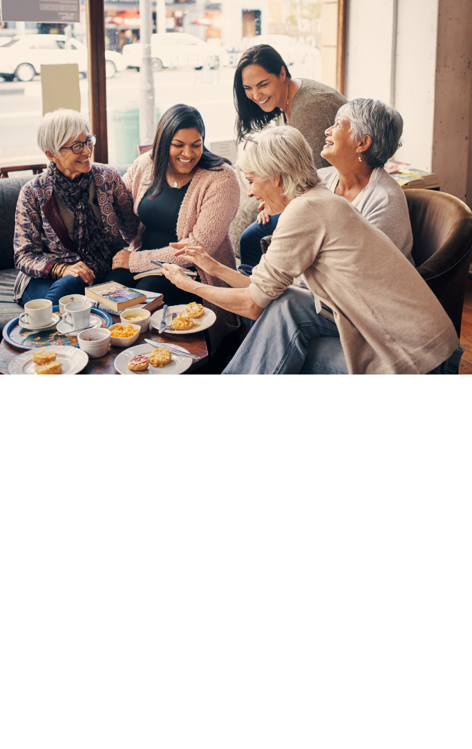women sitting around a table for a book club in a coffee shop