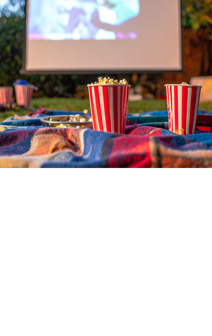 people watching a movie outside 