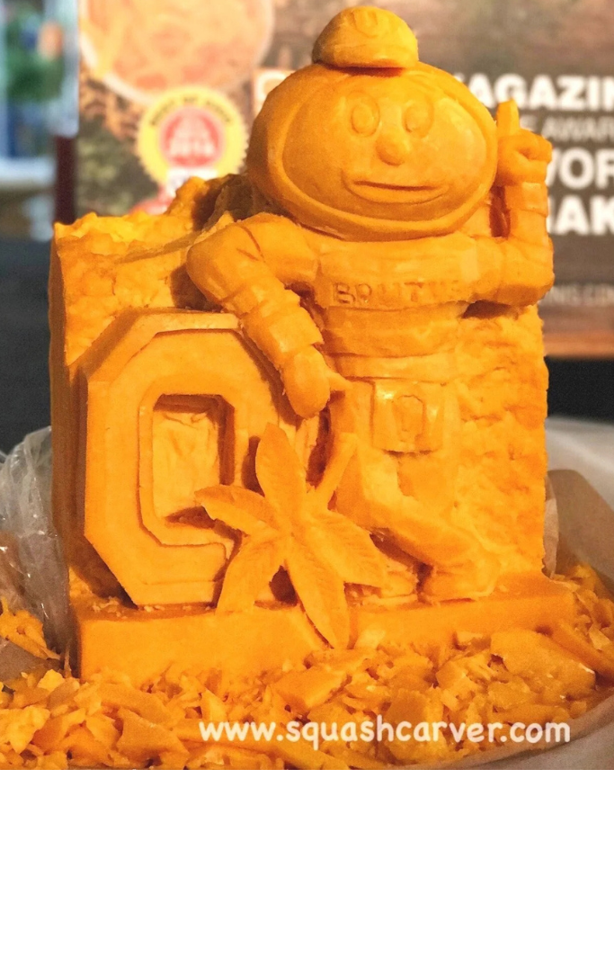 a block of cheese carved into the Ohio State buckeye mascot