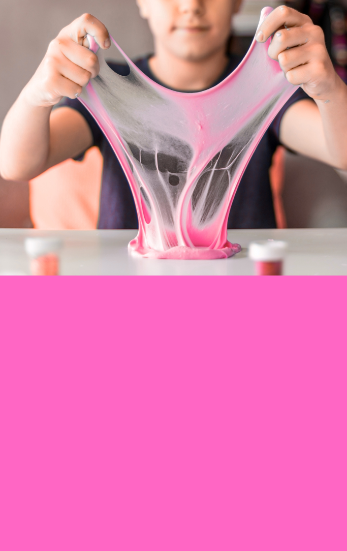 a boy stretching bubble gum on a table like a science experiment