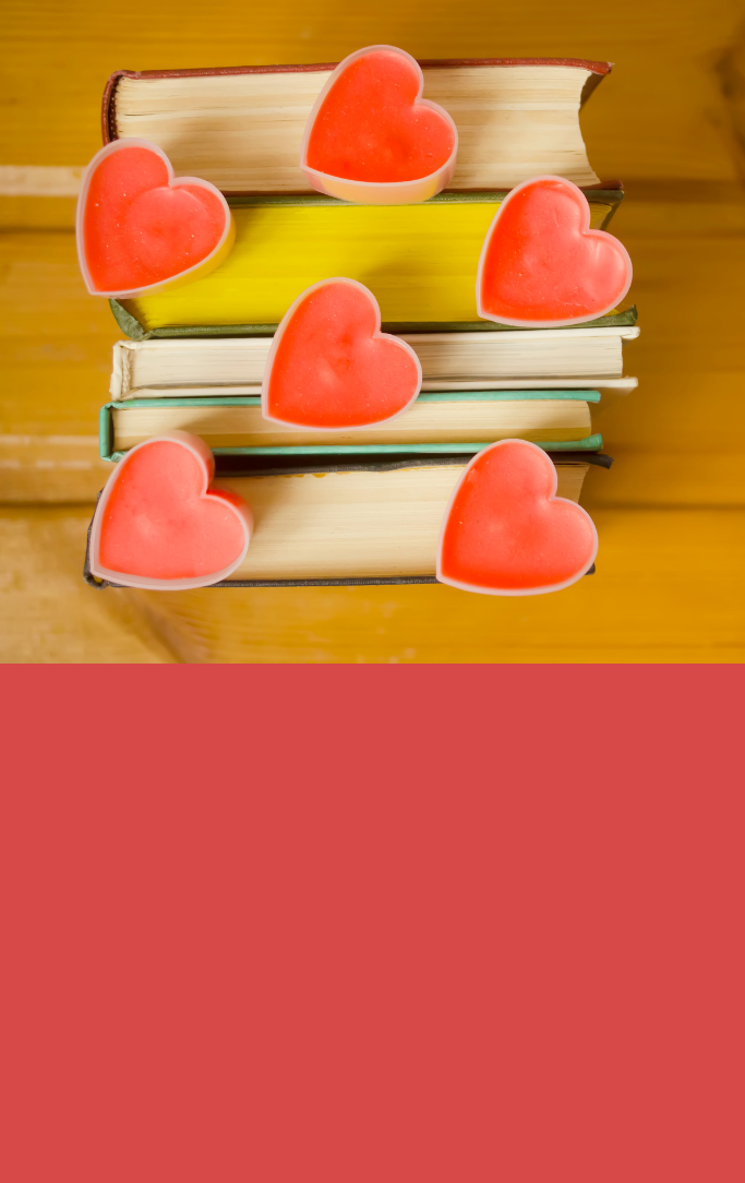 a stack of books with heart tins resting on top of them