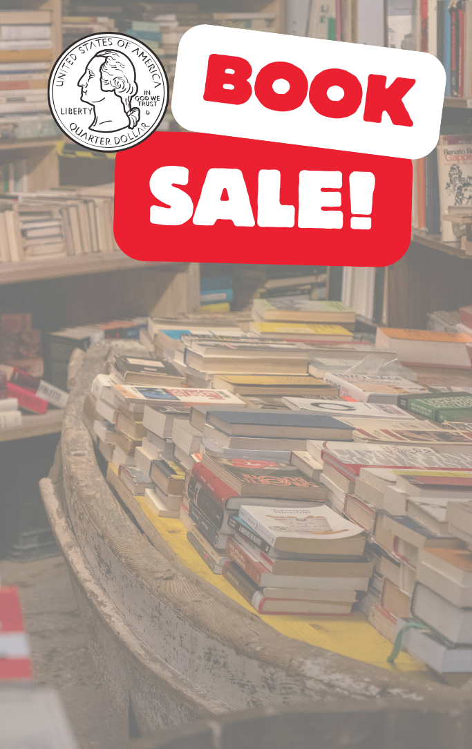 a table and shelves filled with books advertising for a book sale