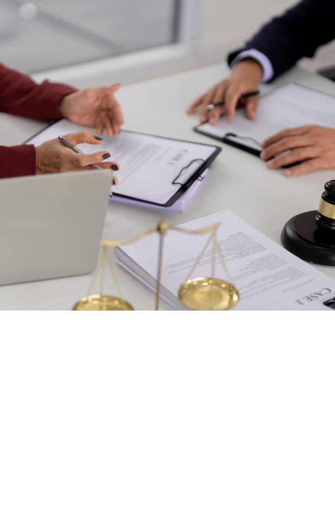 hands gesturing to legal paperwork at a desk 
