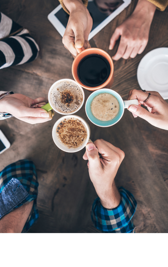 people making a cheers gesture with coffee mugs
